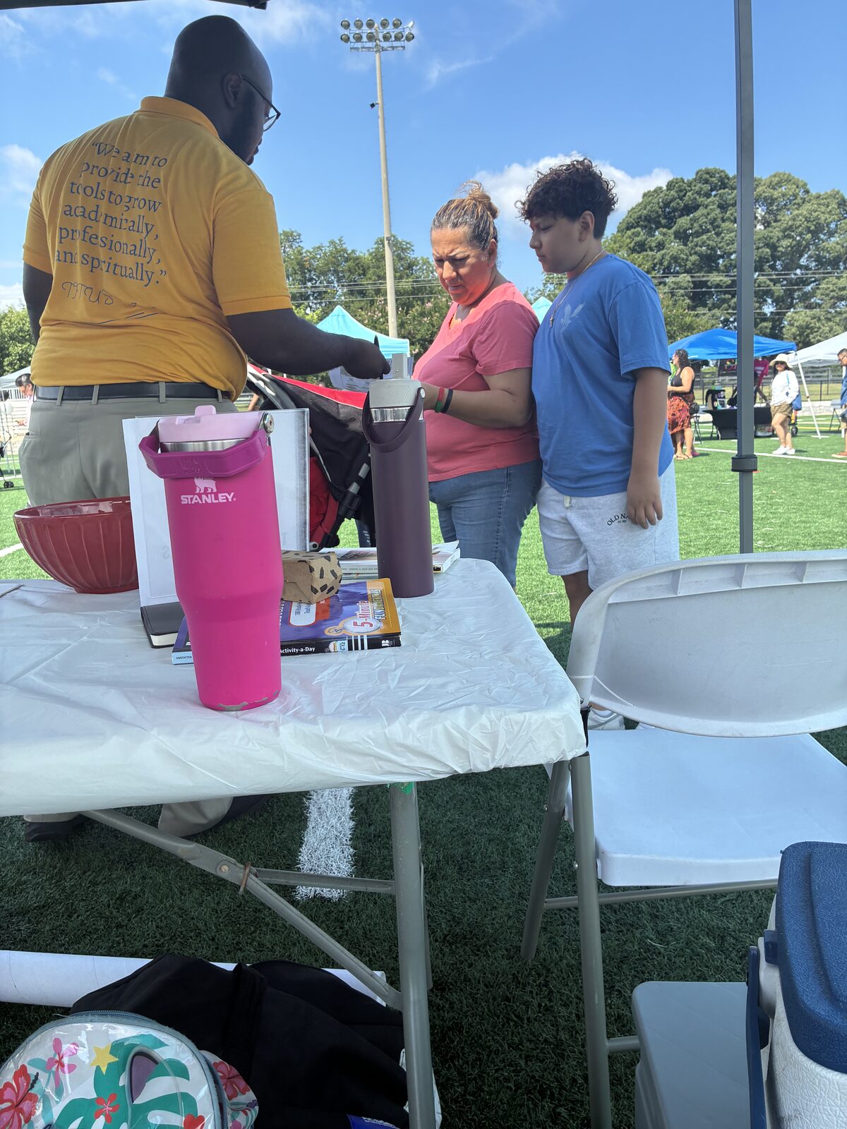 IIA founder speaking with a parent and student at a community event in Gwinnett County